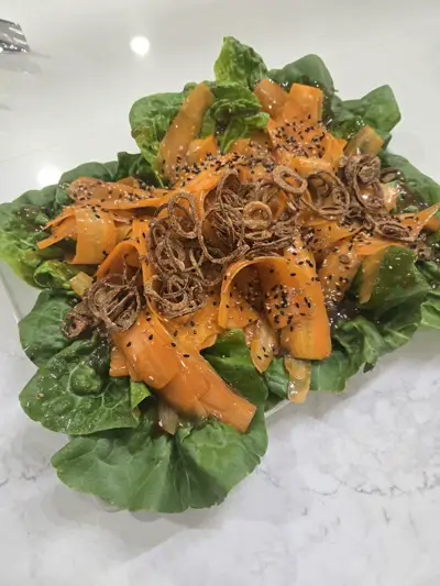 Carrot ribbon salad with crispy shallots and black sesame — creative vegetable dish by Chef Mollie Nashville