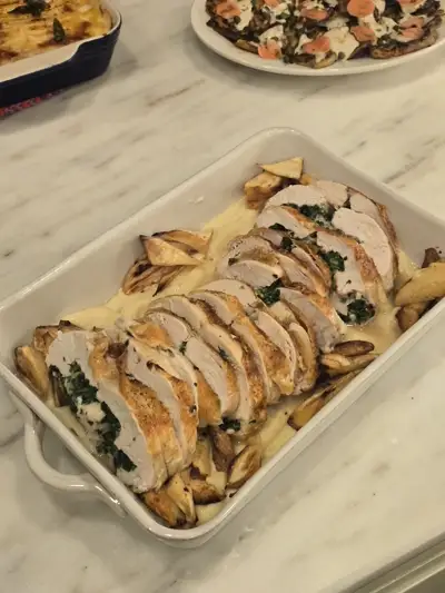 Sliced stuffed chicken roulade with pan sauce and roasted potatoes — private dinner course by Chef Mollie
